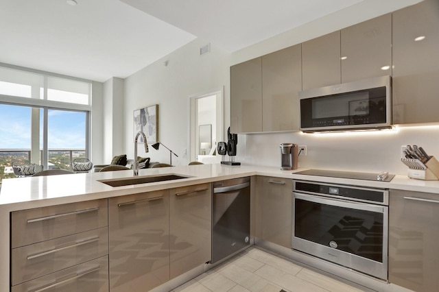 kitchen featuring gray cabinets, appliances with stainless steel finishes, light tile patterned floors, sink, and kitchen peninsula