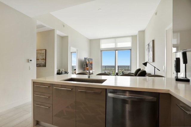 kitchen with sink, dishwasher, and light hardwood / wood-style flooring