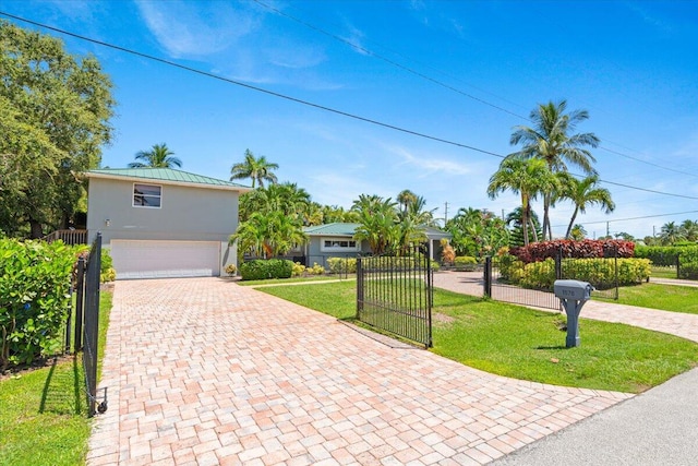 view of front of home featuring a garage and a front lawn