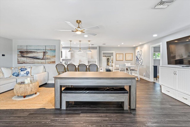 living room with dark hardwood / wood-style flooring and ceiling fan