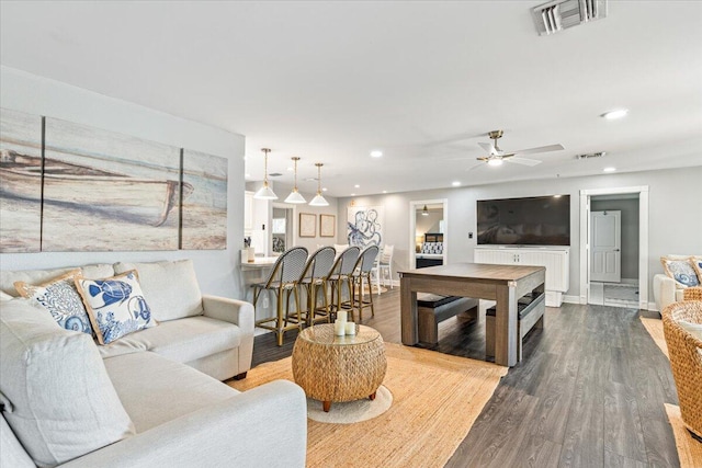 living room with ceiling fan and wood-type flooring