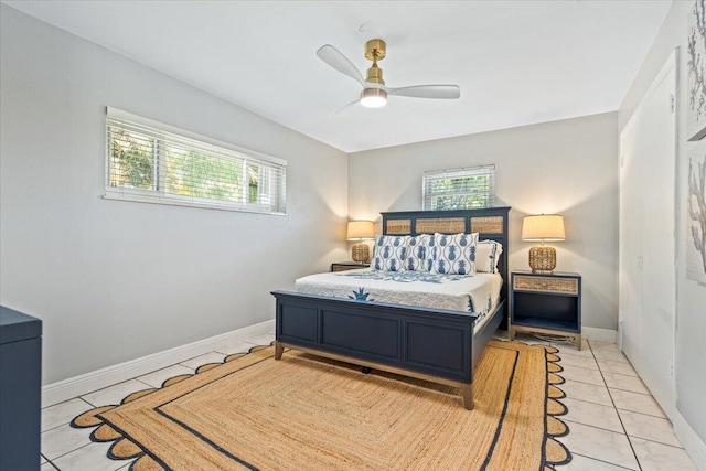 bedroom with ceiling fan and light tile patterned floors