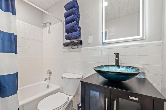 full bathroom with vanity, shower / tub combo with curtain, tile walls, toilet, and decorative backsplash