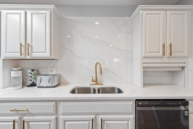 kitchen featuring dishwasher, light stone counters, sink, and white cabinetry