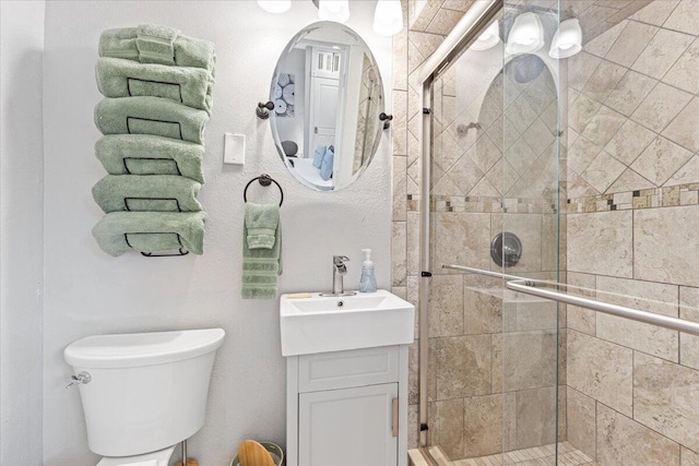 bathroom with vanity, toilet, and an enclosed shower