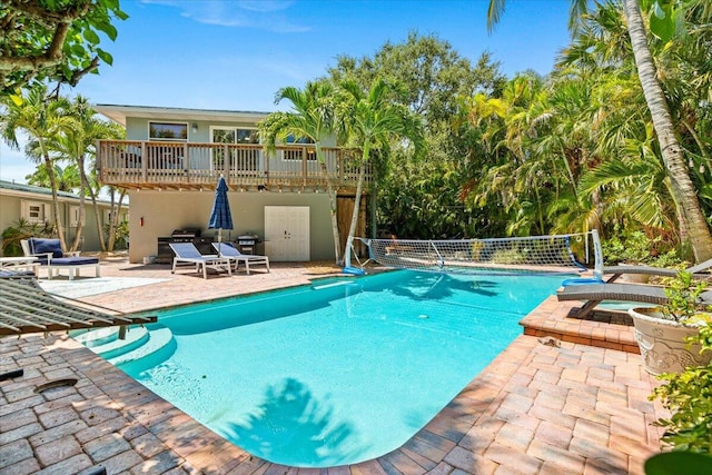 view of pool with a patio area and an in ground hot tub