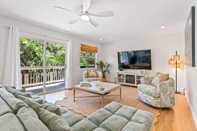 living room featuring ceiling fan and light wood-type flooring