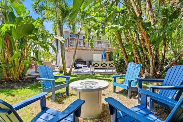 view of patio with an outdoor living space with a fire pit