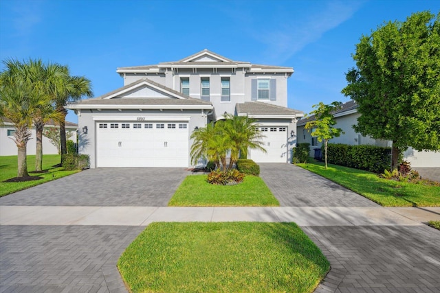 view of front facade featuring a garage and a front lawn