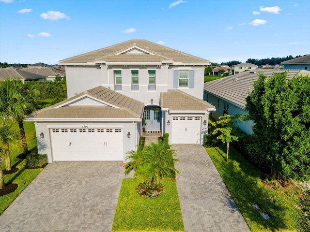 view of front facade with a front lawn and a garage