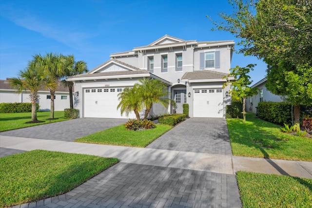 view of front of home featuring a front yard and a garage