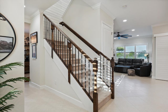 stairway with ceiling fan and crown molding