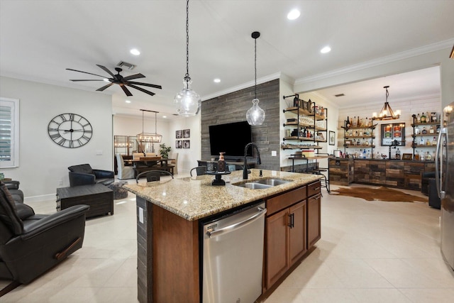 kitchen with a center island with sink, sink, stainless steel dishwasher, light stone countertops, and decorative light fixtures