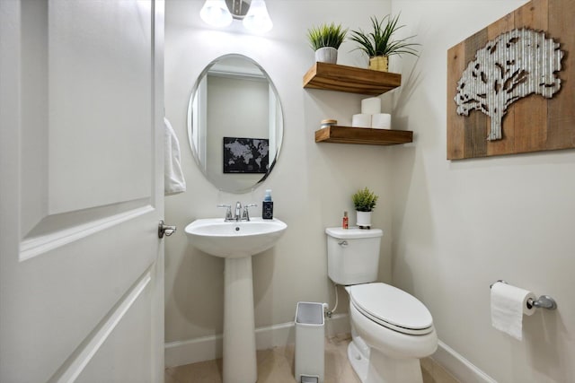 bathroom with tile patterned floors, toilet, and sink