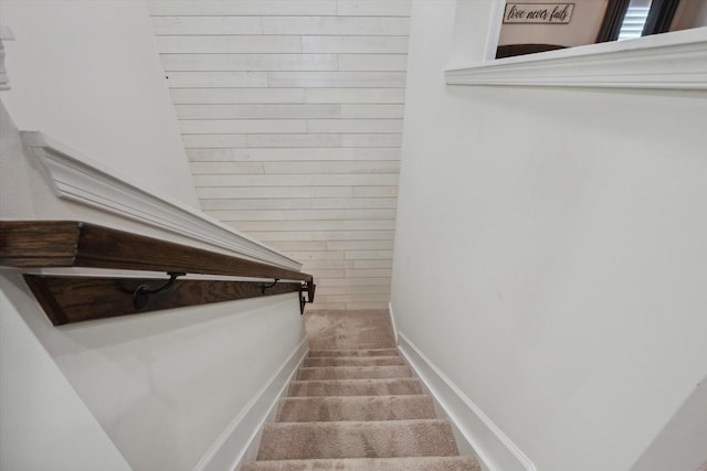 stairway featuring carpet flooring