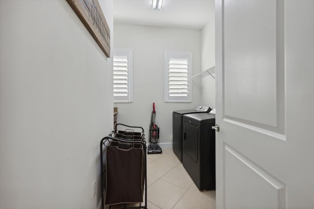 laundry room with washing machine and clothes dryer and light tile patterned flooring