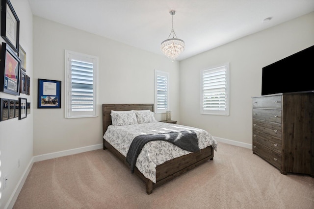 carpeted bedroom with an inviting chandelier