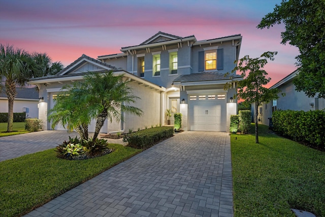 view of front facade featuring a yard and a garage