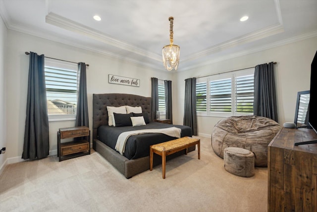 carpeted bedroom with a raised ceiling, multiple windows, and ornamental molding