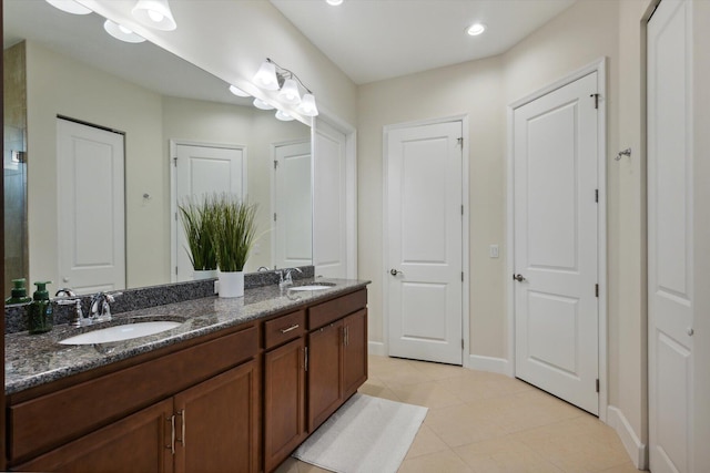 bathroom with tile patterned flooring and vanity