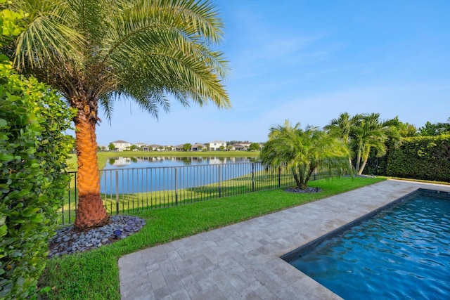 view of pool featuring a yard and a water view