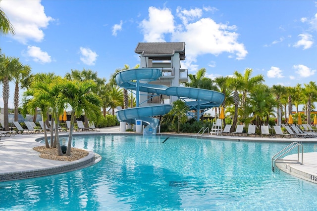 view of swimming pool with a patio and a water slide