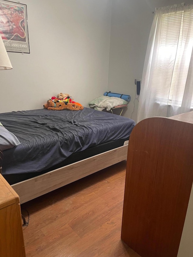 bedroom with hardwood / wood-style floors