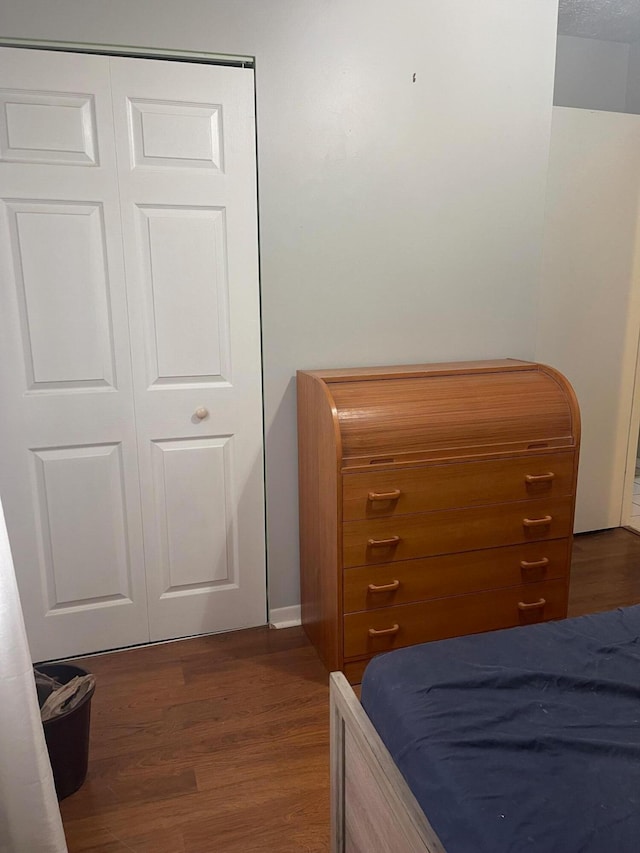 bedroom featuring a closet and dark hardwood / wood-style flooring