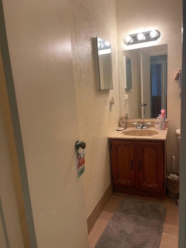 bathroom with vanity, toilet, and tile patterned floors