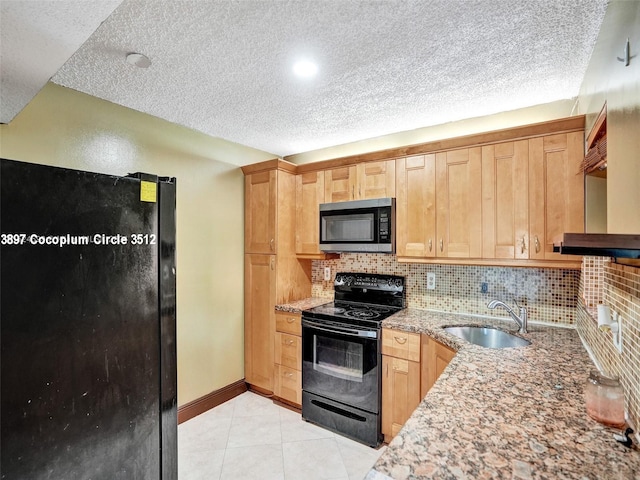 kitchen featuring backsplash, sink, a textured ceiling, and black appliances