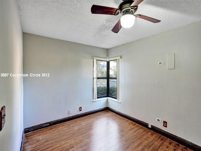 empty room with ceiling fan, a textured ceiling, and light hardwood / wood-style floors