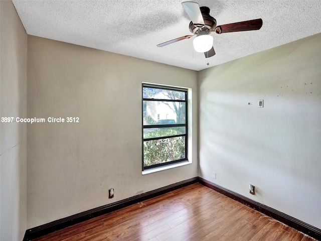 spare room featuring a textured ceiling, ceiling fan, and hardwood / wood-style floors