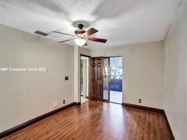 spare room featuring ceiling fan, a textured ceiling, and hardwood / wood-style floors