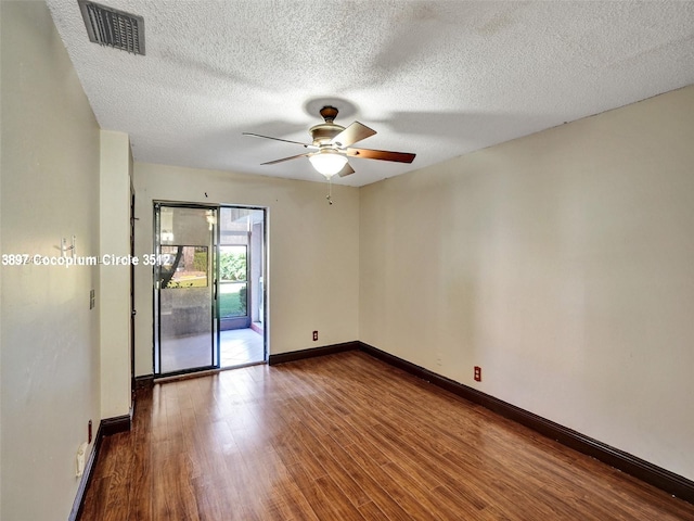 spare room featuring a textured ceiling, ceiling fan, and wood-type flooring