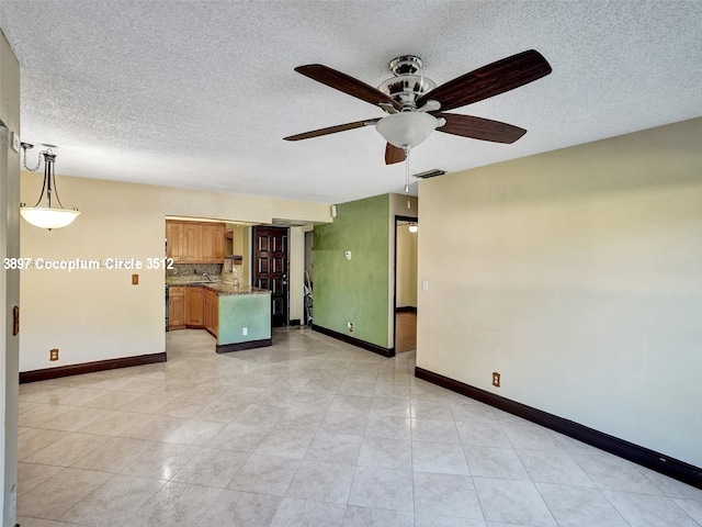 interior space with ceiling fan and a textured ceiling