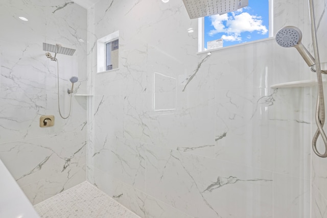 bathroom with a tile shower