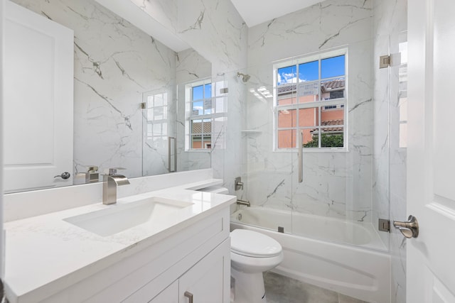 full bathroom featuring tiled shower / bath combo, tile patterned floors, toilet, and vanity