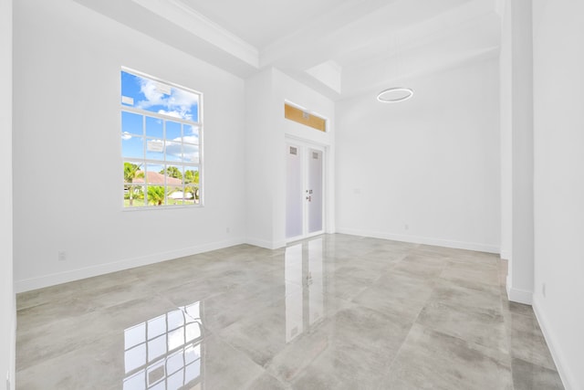 tiled empty room featuring ornamental molding