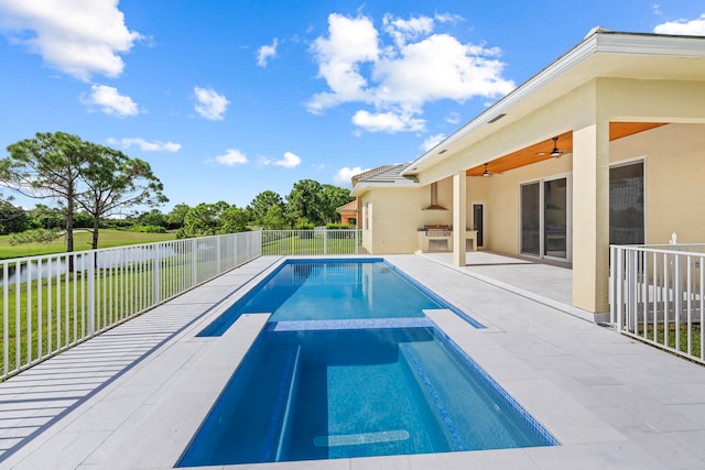 view of swimming pool with a lawn and ceiling fan