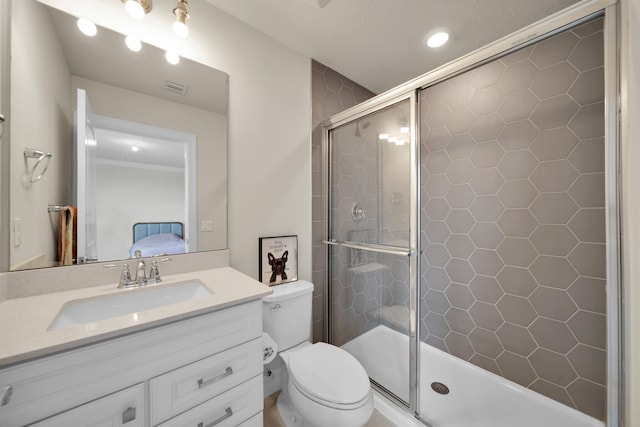 bathroom featuring toilet, an enclosed shower, vanity, ornamental molding, and a textured ceiling