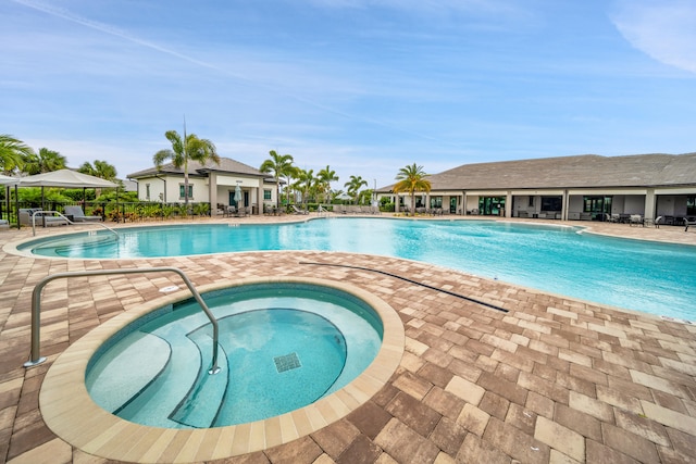 view of pool featuring a community hot tub and a patio area