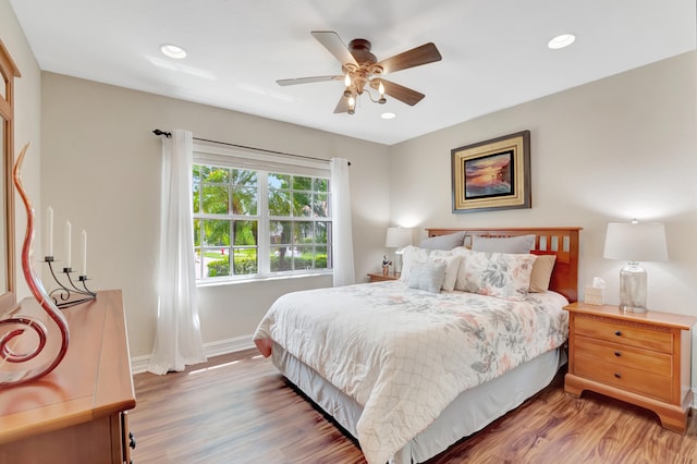 bedroom with ceiling fan and hardwood / wood-style floors