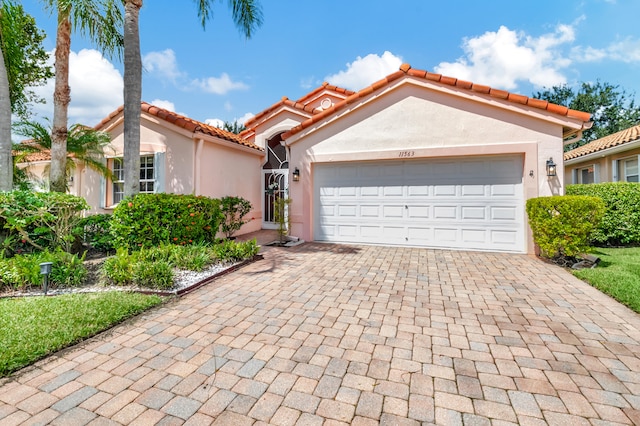 mediterranean / spanish-style home featuring a garage