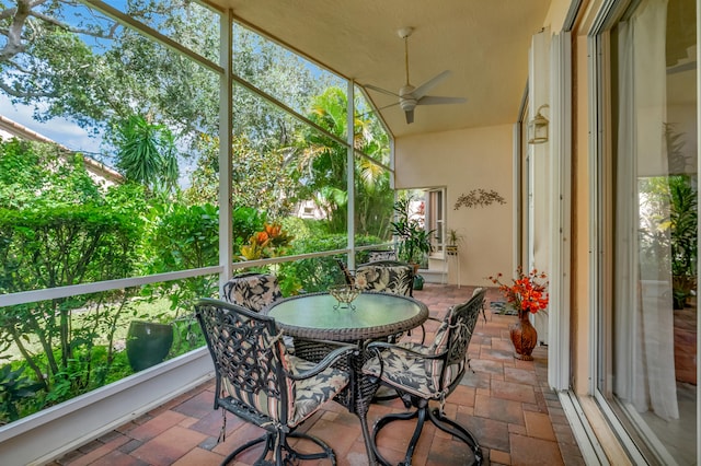 sunroom / solarium with ceiling fan and a healthy amount of sunlight