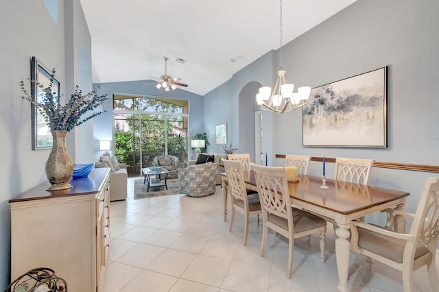 tiled dining space featuring high vaulted ceiling and ceiling fan with notable chandelier