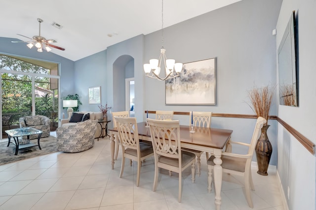 dining space featuring high vaulted ceiling, ceiling fan with notable chandelier, and light tile patterned floors