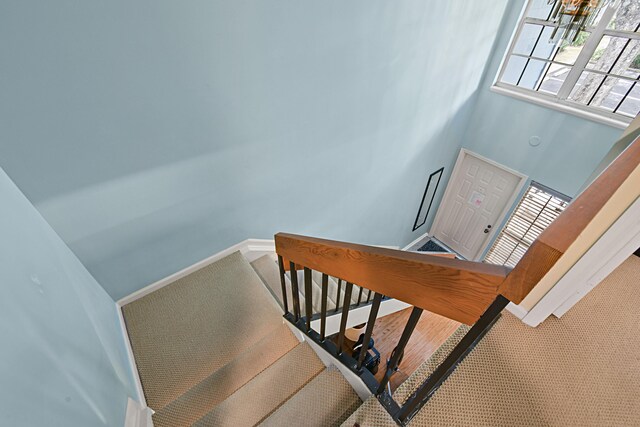 stairway featuring an inviting chandelier