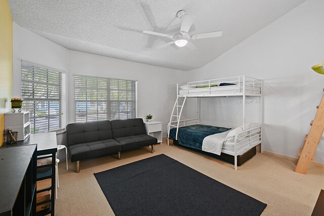 bedroom featuring light colored carpet, a textured ceiling, lofted ceiling, and ceiling fan