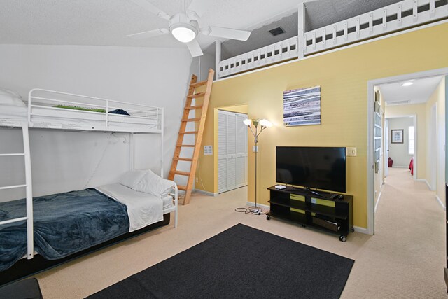 carpeted bedroom featuring a closet and ceiling fan