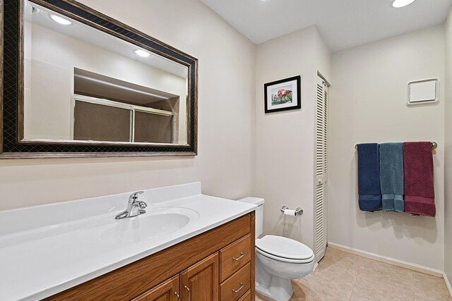 bathroom featuring toilet, vanity, and tile patterned floors